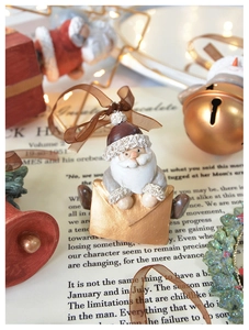 Detailed view of vintage Christmas tree ornaments with resin Santa and festive bells
