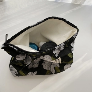 Top view of vintage floral jacquard pouch showing zipper opening and canvas lining interior