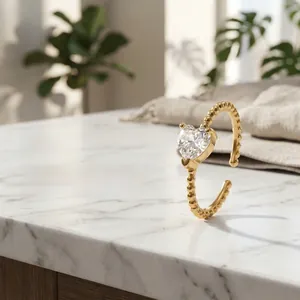 Detail of 18K gold-plated beaded ring with a sparkling heart-shaped zirconia stone