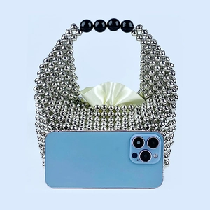 Silver beaded pillow bag with black bead handle and smartphone for size comparison