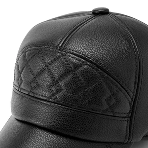 Detailed close-up of black PU leather baseball cap with diamond quilted stitching