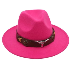 Close-up of silver bull head buckle on brown leather band of a rose red felt cowboy hat