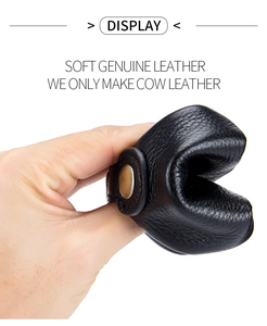 Close-up of flexible black genuine cow leather coin pouch showing soft texture and durability