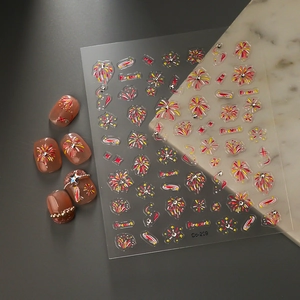Detailed 3D firework nail art stickers with glitter rhinestones on a brown manicure