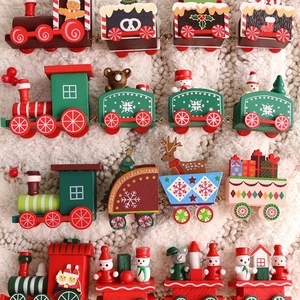 Handcrafted wooden Christmas train sets with snowmen and reindeer on white plush carpet