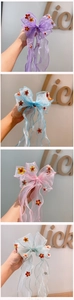 Detail of embroidered tulle hair clips with colorful floral patterns in multiple pastel shades
