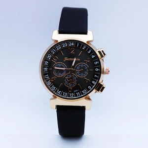 Close-up of golden metal case with black functional dial and textured silicone strap