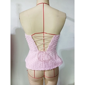 Detail of pink backless top showing 3D rose flower texture and criss-cross straps