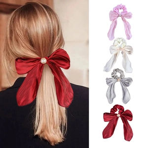Elegant satin scrunchies with large bow and pearl details in red, pink, white, and grey