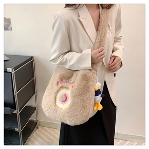 Detail of khaki plush shoulder bag with donut embroidery and cute duck charm pendant
