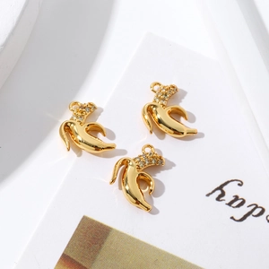 Detailed view of three 18K gold plated banana pendants with zircon stones for DIY jewelry