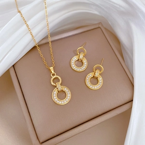 Elegant gold titanium steel interlocking ring jewelry set with crystals on display