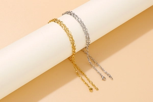 Detailed view of minimalist gold and silver O-link chains with lobster clasps