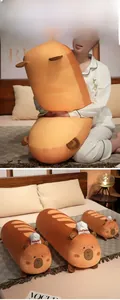 Set of three soft Capybara bread plush pillows in various sizes on a bedroom bed