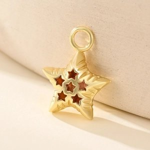 Polished gold star shaped pendant with small cutout star patterns and a top loop ring