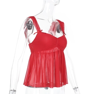 Detail of red mesh camisole featuring delicate bow straps and pleated ruffled hem design