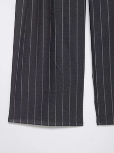 Detail view of the hem on dark grey pinstriped wide-leg trousers in woven fabric