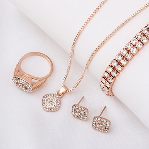 Detail of rose gold geometric jewelry set with sparkling square pavé crystal charms