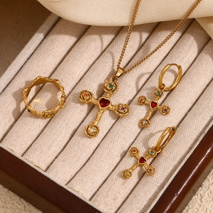 Detail of 18K gold-plated necklace and earrings set featuring colorful crystal crosses