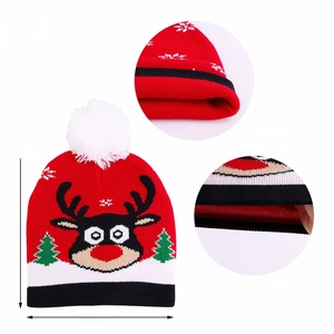 Close-up of double layer red Christmas knit hat with reindeer pattern and pompom