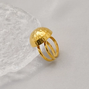 Detailed view of 18K gold ring featuring a hammered texture dome and double-band design