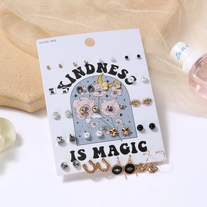 Detail view of various nickel-free earrings set with pearls and rhinestones on card