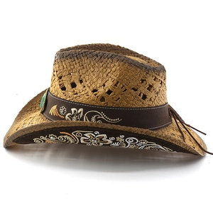 Detail of hand-woven straw cowboy hat featuring floral embroidery and turquoise stone