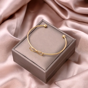 Detail of rose gold infinity open bangle presented on a premium velvet jewelry gift box