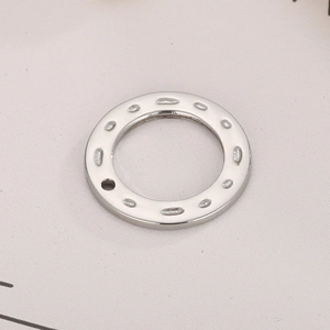 Close-up of a silver stainless steel geometric hammered ring pendant for jewelry DIY
