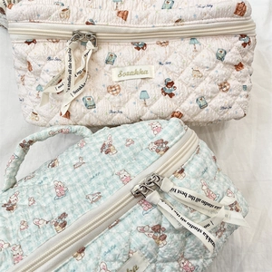 Quilted cosmetic bags featuring cute bear and rabbit patterns with ribbon zipper pulls