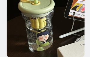 Detail of glass water bottle with tea infuser, cartoon graphics, and dual-use straw lid