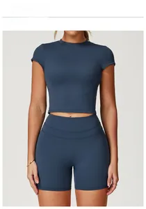Front view of badge blue yoga set featuring a cropped short sleeve top and high waist shorts