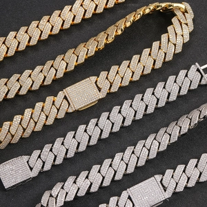 Close-up of four luxury iced-out Cuban link bracelets in gold and silver finishes