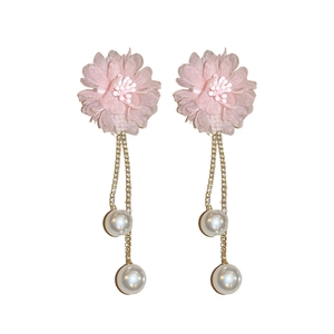 Pink lace flower earrings with long gold tassels and faux pearls on white background