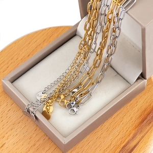 Minimalist gold and silver stainless steel link bracelets set in a jewelry box