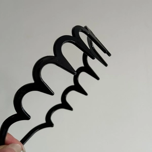 Simple black wave headband made of flexible plastic for secure hair styling and daily use