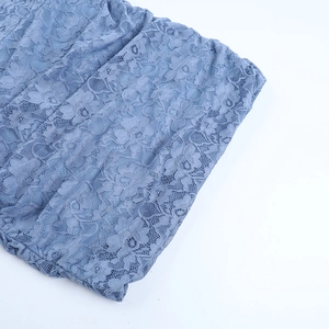 Detailed view of blue floral lace fabric and delicate embroidery on this slim dress