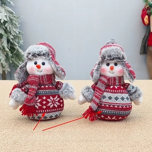 Close-up of two cute knitted Christmas snowman plush dolls with red and grey textures