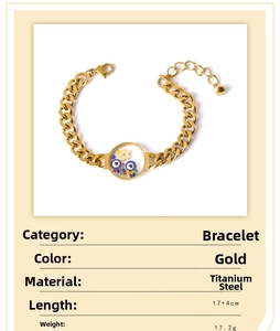 Detail of gold titanium steel curb bracelet with round pendant and color beads