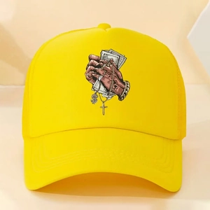 Detail of yellow trucker hat with hip-hop graphic showing hands holding dollar bills