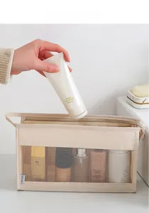 Close-up of beige mesh travel toiletry bag showing spacious capacity for skincare products