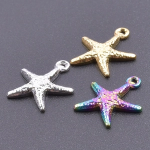 Three starfish pendants in gold, silver, and rainbow steel finish on a black background