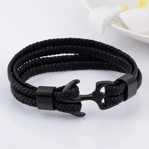 Detail of multi-layer black braided leather bracelet with black metal anchor hook clasp