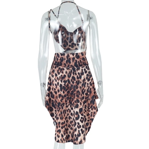 Detail of leopard print mini dress featuring adjustable straps and irregular hemline