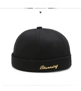 Close-up of black cotton docker hat featuring stunning cursive embroidery on front