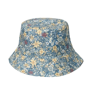 Detailed close-up of blue floral sun hat with yellow and pink flower prints for women