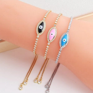 Three gold-plated Evil Eye bracelets with colorful enamel and zircon stones on a display