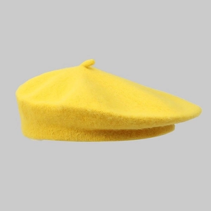 Close-up of a yellow wool beret showing soft fabric texture and the top stem detail