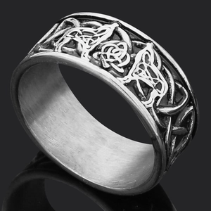 Detailed macro view of vintage Viking runes and Celtic knot reliefs on a steel ring