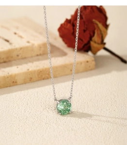 Macro shot of S925 silver necklace featuring a round Paraiba green gemstone pendant